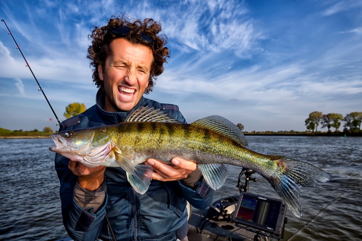 Happy fisherman with a zander